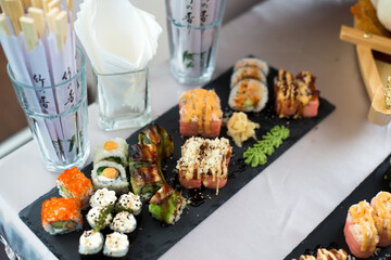 Close up view of assorted sushi - japanese sushi food. Maki and rolls with tuna, salmon, shrimp, crab and avocado.