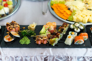 Close up view of assorted sushi - japanese sushi food. Maki and rolls with tuna, salmon, shrimp, crab and avocado.