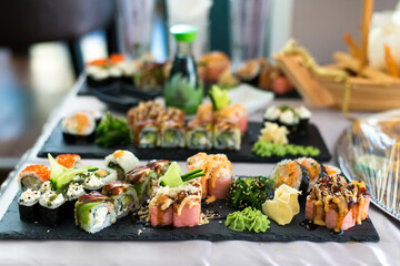 Close up view of assorted sushi - japanese sushi food. Maki and rolls with tuna, salmon, shrimp, crab and avocado.