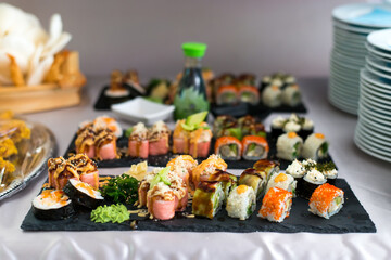 Close up view of assorted sushi - japanese sushi food. Maki and rolls with tuna, salmon, shrimp, crab and avocado.