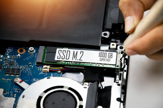 Technician is installing M.2 SSD onto motherboard.