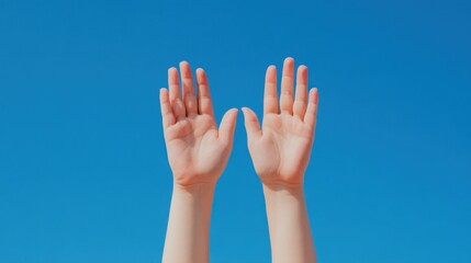 Two hands raised high against a vibrant blue sky. The image is bright, cheerful, and evokes a sense of freedom or hope. The hands appear to belong to