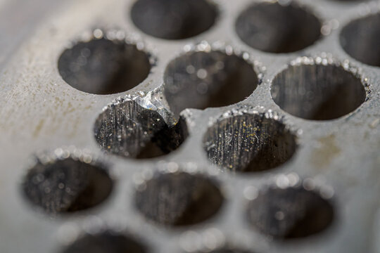 Detail of a damaged metal planchet from a grinder.
