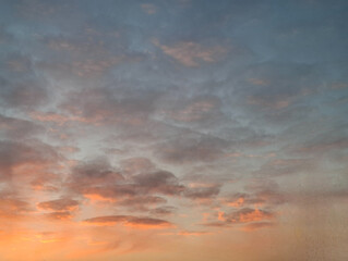 Fototapeta premium sunrise on a winter morning the sun's rays painted the bottom layer of clouds in the sky pink