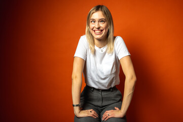Portrait of a funny young, emotional girl making a fish face, lips and pointing with both hands....