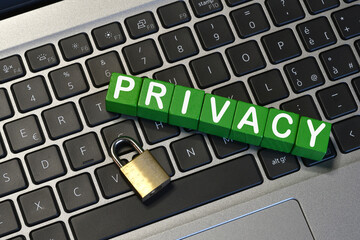 text 'PRIVACY' on a laptop keyboard with a padlock. Cyber ​​security concept