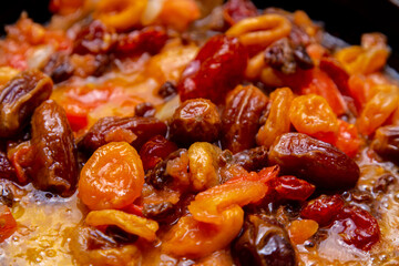 Red beans in tomato sauce with dried fruits stewed in a frying pan.