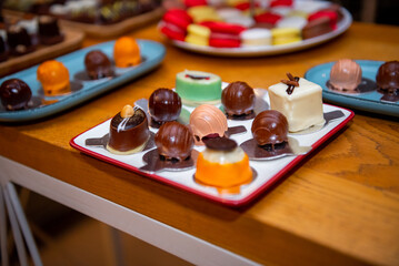 Delightful assortment of artisan chocolates displayed on a vibrant plate at an event dedicated to sweet treats during a festive gathering