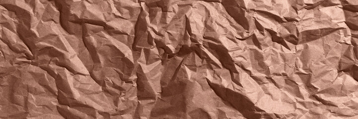 Brown, mocha mousse crumpled, wrinkled recycle craft paper texture background banner.