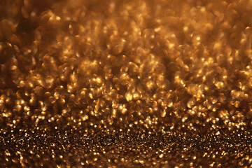 Golden glitter festive bokeh background, abstract defocused texture. Holiday lights