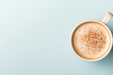 Obraz premium Creamy coffee with sprinkle of cinnamon in minimalist cup on sof