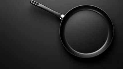 Empty black frying pan on dark surface