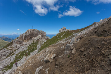 Fototapeta premium View of dark Triassic volcanic dike and light carbonate rocks of biological origin along the path that goes up to the Latemar. UNESCO world heritage site, Trentino-Alto Adige, Italy, Europe