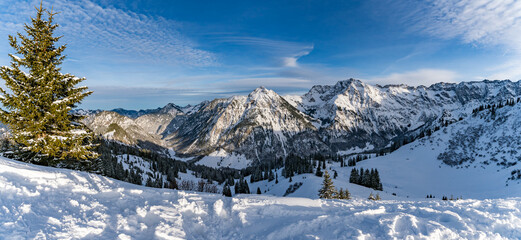 Winter landscape on a sunny day with snow covered mountains and trees near Oberstdorf in Allgau Alps
