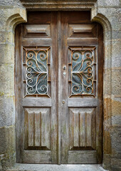 Old wooden brown door with bars