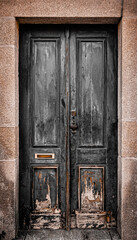 Old wooden black door. Photo in old color image style.