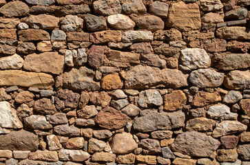 Old colorful stone wall closeup in sunny day