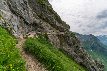 Mountain path along rocky cliffs with scenic view in Bavarian Algau Alps near Oberstdorf