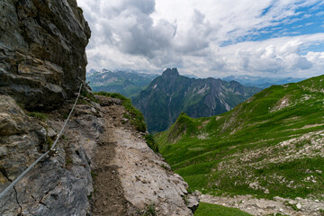 Misty mountain trail with breathtaking view in Allgaeu Alps of Bavaria near Oberstdorf