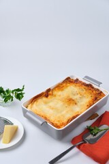 Step-by-step preparation of pancake lasagna or casserole with pancakes and minced meat. Ready-made pancake lasagna or casserole on a white background.