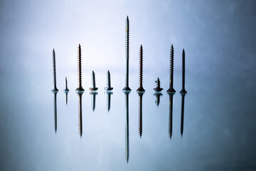 Drill bits isolated on black shiny mirror. Technology illustration. Minimal creative design. Sound, equaliser, sound effect. 