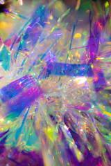 Plastic toy with reflecting material close-up shot. Abstract background with colourful lights.