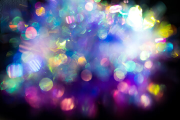 Dreamy close-up image of blurred, overlapping light reflections or bokeh effects, creating vibrant abstract pattern. Creative copy space for design, colourful backdrop. 