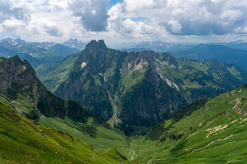 Mountain landscape view with lush green valleys and majestic Hoefats peaks in Bavaria Alps