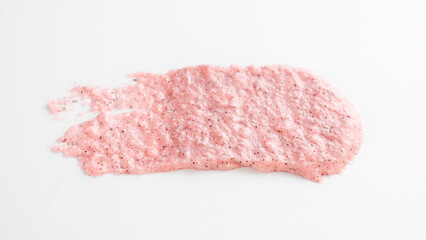 Pink substance is on a white background. It looks like a brush stroke. The brush stroke is pink and has a rough texture