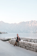 Young woman exploring a quaint European coastal town, embodying the digital nomad lifestyle and the freedom of solo travel serene moment of discovery and balance