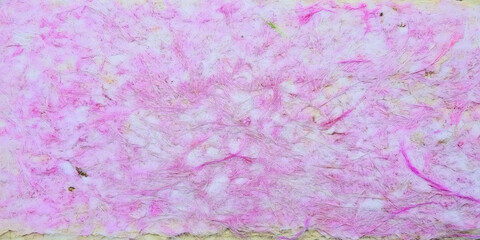 Fototapeta premium A delicate handmade paper texture in soft pastel pink tones, featuring organic fibers and natural imperfections, perfect for artistic and design backgrounds