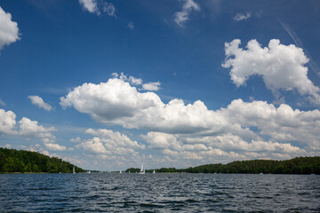 Lake in Polish Masuria with sailing yachts on sunny day, Masurian Lake Land, Poland