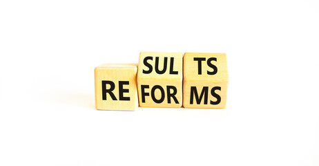 Reform and result symbol. Concept words Reforms Results on beautiful wooden block. Beautiful white...