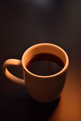 White cup with black hot coffee on the table