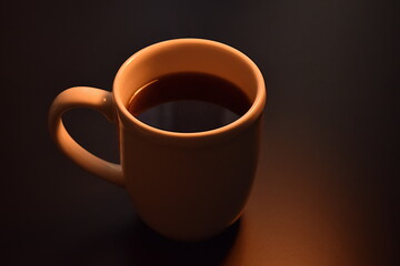 White cup with black hot coffee on the table