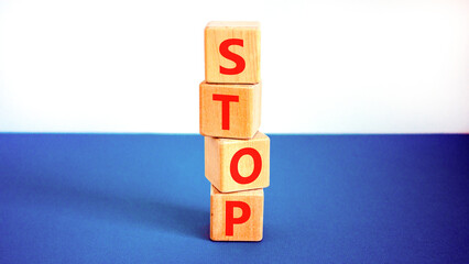 Stop symbol. Concept word Stop on beautiful wooden blocks. Beautiful white and blue background....