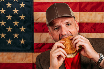 American man eating a hamburger.