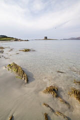 beach and rocks, La Pelosa beach. Stintino, Sassari, Sardinia, Italy.