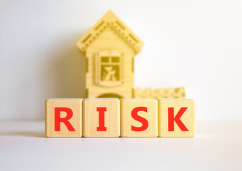 Risk symbol. Concept word Risk on beautiful wooden blocks. Beautiful white table white background. Wooden beautiful house. Business, lifestyle, support and risk concept. Copy space.