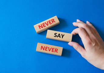 Never say Never symbol. Concept words Never say Never on wooden blocks. Businessman hand. Beautiful...