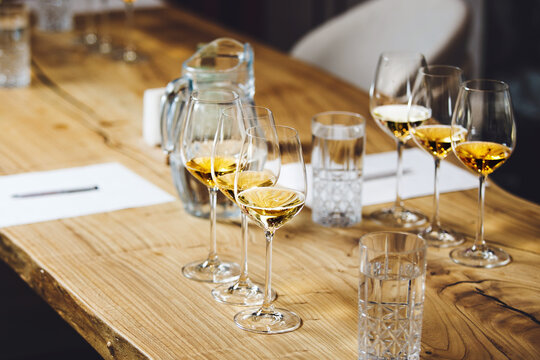 Wine tasting preparation. Various white wines in glasses without name. Blind degustation.