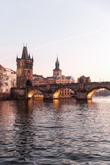 Sunset colors in Prague Historical Gothic Medieval castle, St. Vitus Cathedral, Charles Bridge and river Vltava boat cruise, astronomical clock, Unesco city tourism, golden hour and water reflection