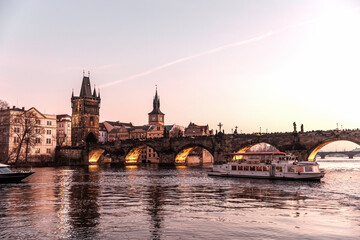 Obraz premium Sunset colors in Prague Historical Gothic Medieval castle, St. Vitus Cathedral, Charles Bridge and river Vltava boat cruise, astronomical clock, Unesco city tourism, golden hour and water reflection