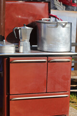 old brown wood stove with the large pot and the moka pot on the hot cast iron plate