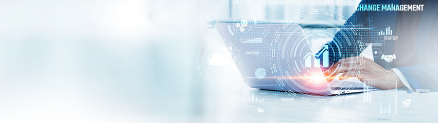 Change Management: Businessman uses laptop to analyze and develop various information about organizational transformation on future virtual interface. Strategy, communication, employee engagement