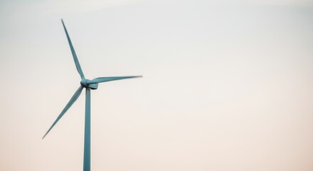Solitary wind turbine against clear sky: renewable energy and sustainability focus
