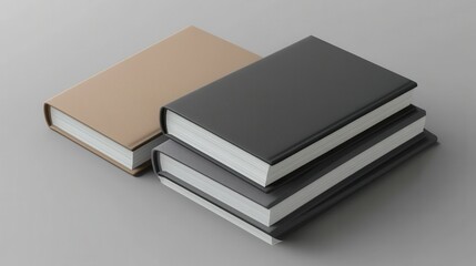 Stack of three hardcover books in neutral tones on grey surface
