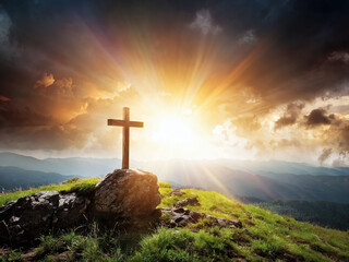 Cross on a hilltop at sunrise with dramatic clouds and sunlight breaking through the sky