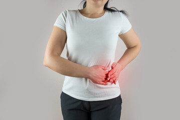 Pain in the side. Pain in the spleen. Young woman suffers from abdominal pain.