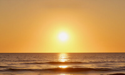 Fototapeta premium Ocean Sunset with golden waves and horizon glow